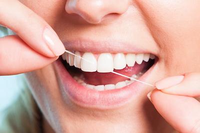 girl flossing her teeth in west perth